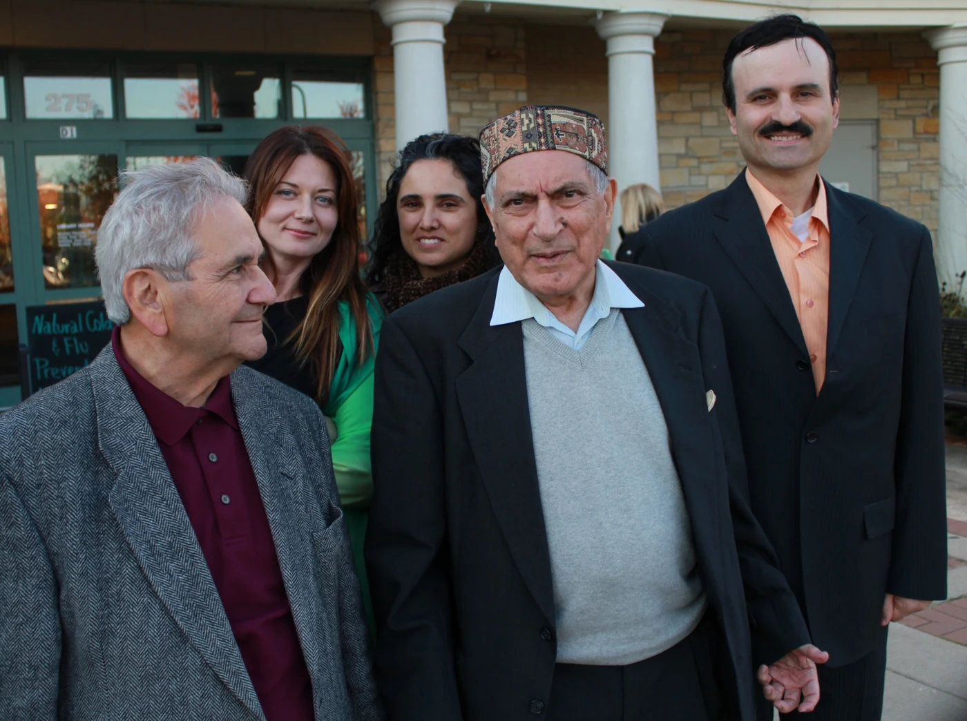 Ishwar Puri standing outdoors with a group of visitors